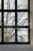 Closeup of an old window. Feeling trapped, scared, depressed and lonely during lockdown. Hiding inside at home, suffering from social anxiety, longing and looking to escape house for change and hope