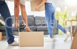 This ones done. Shot of an unrecognizable couple packing boxes for their move at home.