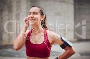 Tunes that move you. Cropped shot of an attractive young female athlete listening to music while running outdoors.