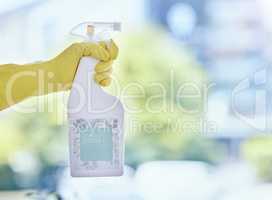 Magic in a bottle. Shot of an unrecognizable woman holding a cleaning product while cleaning her apartment.