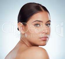 Closeup portrait of beautiful woman with smooth glowing face. Headshot of caucasian model isolated against a grey background in studio and posing. Young woman with healthy skin and routine skincare