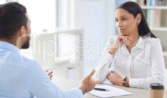 Mixed race hiring manger in interview with businessman. CEO with resume and cv of candidate looking for job opening, vacancy, office opportunity. Applicant sitting and explaining experience to hr boss