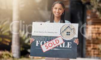 This is my hustle. Shot of a real estate agent standing next to a sold sign outside.
