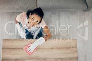 I have a few tips on keeping your house spotless. Shot of a woman wiping surfaces at home.