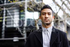 Off to work I go. Cropped portrait of a handsome young businessman standing outside during his morning commute into work.