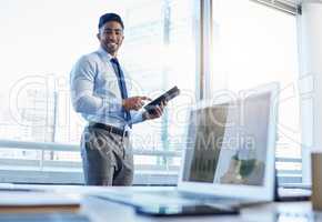 Take advantage of the endless opportunities in the market right now. Shot of a businessman using a digital tablet while standing in his office.