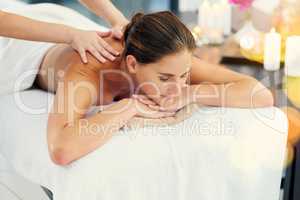 No more knots. a beautiful young woman lying on a massage table at the day spa.