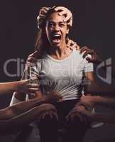 Its a wound to the soul that never heals. Shot of a young woman experiencing mental anguish and screaming against a black background.