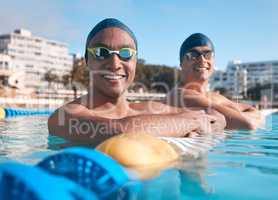 Life in the blue lane. Portrait of two young men going for a swim in an olympic pool.