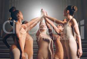 Dance is your pulse, your heartbeat, your breathing. a group of ballet dancers giving each other high fives.