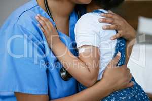 Thank you for making me better. Shot of a nurse hugging a little girl with a plaster on her arm.