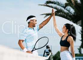 Well done. Shot of tennis teammates sharing a high five during a tennis match.