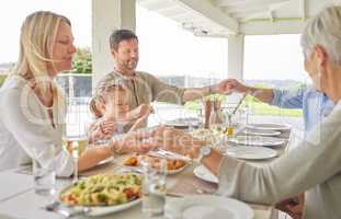 We have to do this more often. Shot of a family praying together before enjoying sunday lunch.