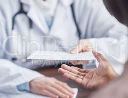 Take this to the pharmacy to receive your medication. Closeup shot of an unrecognisable doctor giving a patient a letter during a consultation in a medical office.