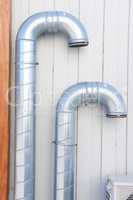 Ventilation. Ventilation pipes on a building wall. Equipment for fresh air and architecture. Two metal tubes used in the construction industry for a duct system or air conditioner, ready to install.