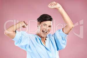 Cheer your own successes. Cropped portrait of an attractive young woman cheering in studio against a pink background.