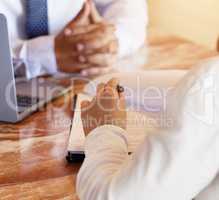 Signing the contract. an unrecognizable car salesman talking to a customer in his office at the car dealership.