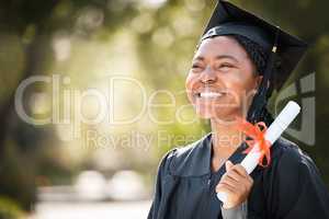 This feels like a miracle come true. Shot of a young woman holding her diploma on graduation day.