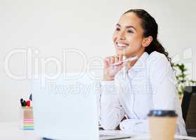 I cant wait to be successful. an attractive young businesswoman sitting alone in the office and looking contemplative while using her laptop.