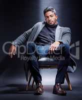 Turn up the charm. Studio portrait of a handsome and fashionable young man posing against a dark background.