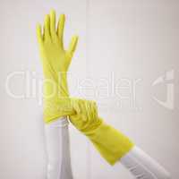 Lets get this place clean and sparkly. a woman putting on yellow rubber gloves.