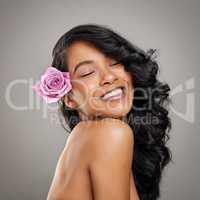 You deserve to feel fabulous. Shot of a beautiful young woman posing with a flower in her hair.