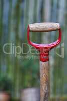 Closeup of a shovel handle in an empty garden, reqady to be used with copyspace. Zoom in on wooden patterns and texture of a gardening tool with copy space. Garden cleanup made easier with a gadget