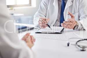 These forms are very important. an unrecognizable doctor having a consultation with a patient at a clinic.