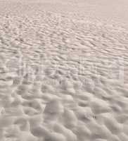 Beach sand from desert dunes with ripples along the coast in nature on a sunny day. Closeup of a scenic landscape on the seashore with copyspace background outdoors. A calm place to feel zen