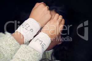 Hiding your hurt wont make it go away. a woman with bandages wrapped around her wrists showing help written on them.