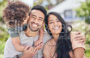 A happy family is the ultimate goal in life. Portrait of a happy family relaxing together outdoors.
