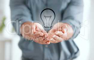 Take care of your energy. an unrecognizable businessperson holding out their hands with a lightbulb placed in it at work.