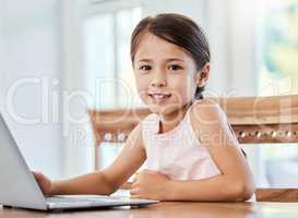Live your life with love as your guiding principle. Shot of a little girl using a laptop at home.