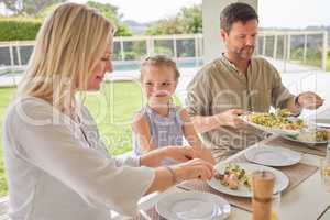 She has always has interesting things to say. Shot of a family enjoying sunday lunch together on their patio.