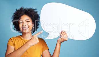 We were all thinking and saying it. an attractive young woman standing alone against a blue background in the studio and pointing at a chat bubble.