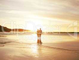 Self-control is for hoarders. Rearview shot of an unrecongnizable couple enjoying a romantic walk at the beach.