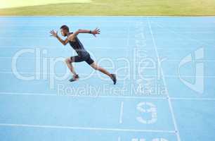 Athlete running on track during competitive training practice. Full length athletic, fit, active male runner sprinting with speed in sports centre. Exercising cardio health and stamina in workout