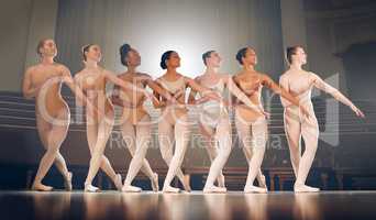 Dancing is like dreaming with your feet. a group of ballet dancers practicing a routine on a stage.