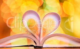 I love reading books and doing my homework A schoolbook with open pages forming a heart sign. Motivation and hard work makes for great grades and a good education.