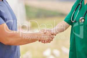 Thank you for your service and care. Closeup shot of an unrecognisable man shaking hands with a veterinarian on a poultry farm.