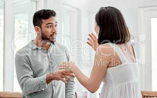 Compromise is a must. Shot of a young couple having an argument at home.