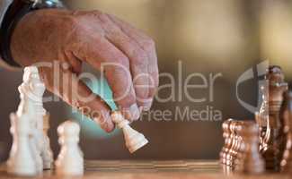 Chess is a mind game. an unrecognisable man playing a game of chess.