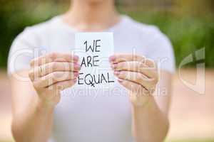 Equality is not in regarding different things similarly. Shot of a unrecognizable woman holding a card in protest in a park.