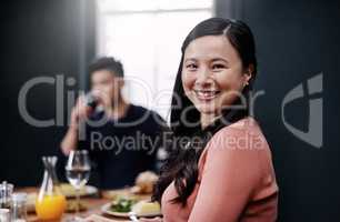 She loves their daily sit down dinners. Portrait of a beautiful young woman having a meal with her husband at home.
