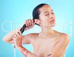 Now Ill apply my conditioner. a woman washing her hair against a blue background.