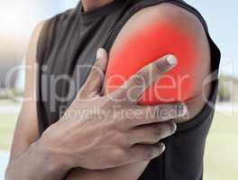 Closeup of sports man suffering from an inflamed shoulder injury. Athletic, active athlete holding and rubbing his sore arm with glowing red cgi. Overworking muscles causes tension, cramp or sprain