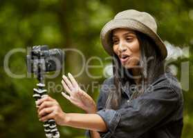 One for the peeps back home. an attractive young woman taking selfies while hiking in the wilderness.