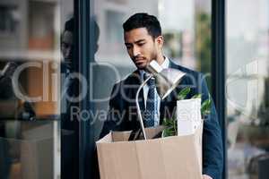 Success is not final, failure is not fatal. a young businessman looking depressed after being retrenched from work.