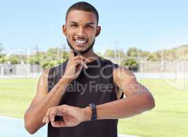 Young athlete using a fitness tracker to monitor progress, heart rate and calories burned during a workout. Portrait of a sportsman checking his pulse with a digital watch while training for exercise