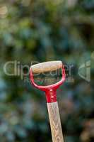 Closeup of wooden shovel handle in a garden or field with copyspace. Zoom in on macro details, patterns and shape of a gardening tool ready to be used in springtime. Digging made easier with tools